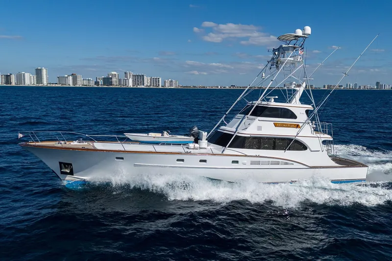 Slide: The Image of 1985 Feadship Yacht Fisherman cruising on ocean with city skyline in background. - 149