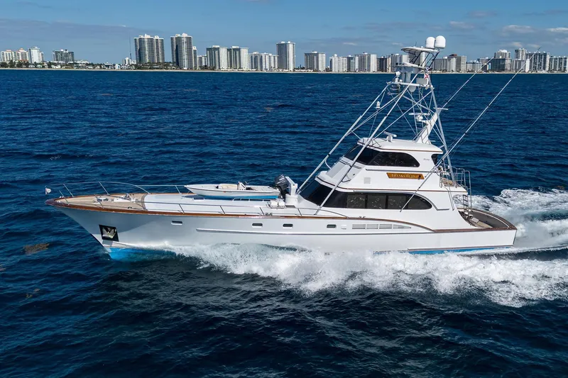 Slide: The Image of 1985 Feadship Yacht Fisherman cruising on ocean with city skyline in background. - 152