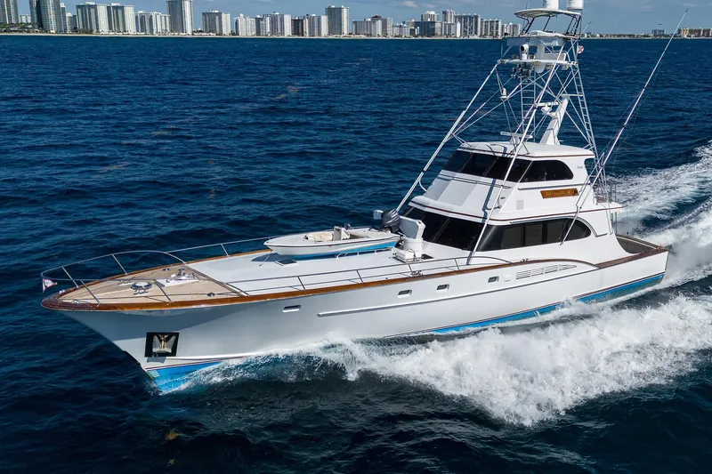 Slide: The Image of 1985 Feadship Yacht Fisherman cruising on ocean near city skyline. - 153