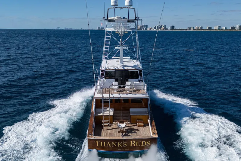 Slide: The Image of 1985 Feadship Yacht Fisherman cruising near city skyline on open sea. - 154