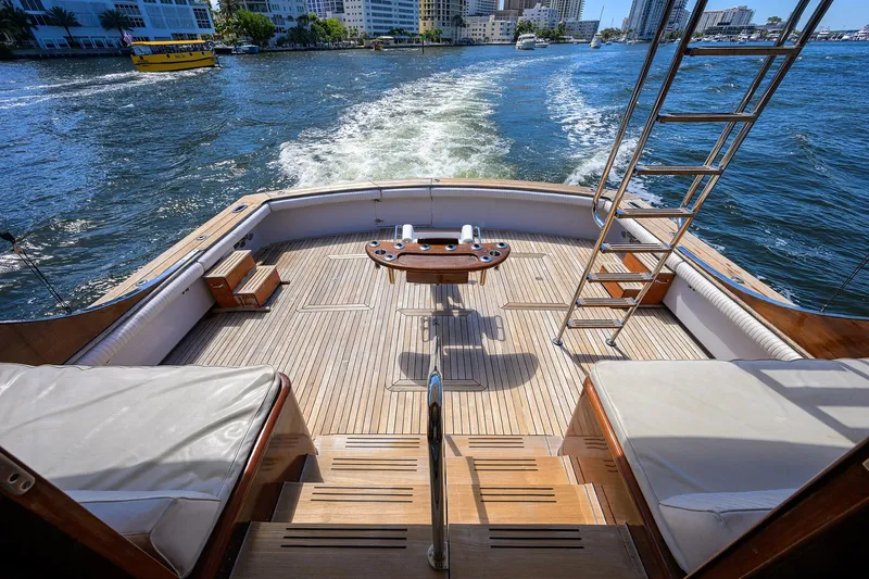 Slide: The Image of 1985 Feadship Yacht Fisherman deck with ocean view, featuring wooden flooring and seating. - 23
