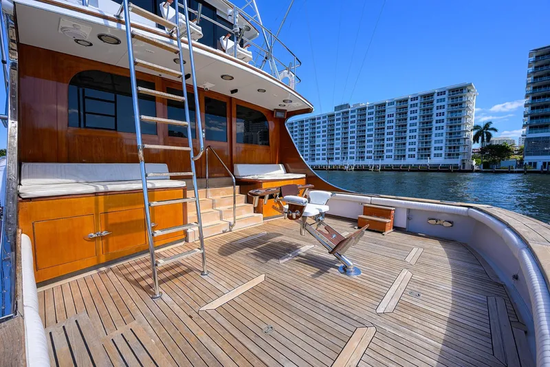Slide: The Image of 1985 Feadship Yacht Fisherman deck with wooden finish, overlooking waterfront buildings. - 26