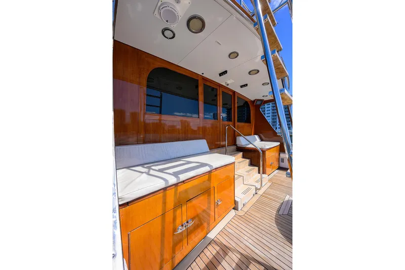 Slide: The Image of 1985 Feadship Yacht Fisherman deck with wooden finish and cushioned seating. - 27