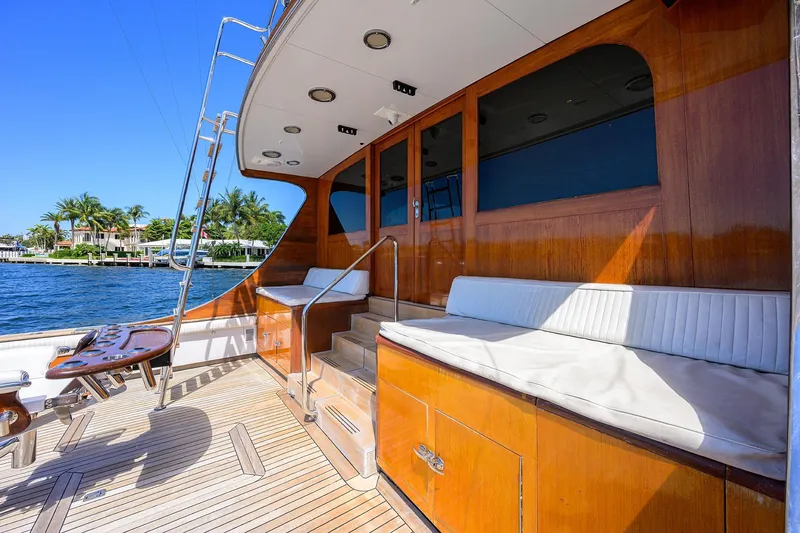 Slide: The Image of 1985 Feadship Yacht Fisherman deck with wooden finish, seating, and ocean view. - 29