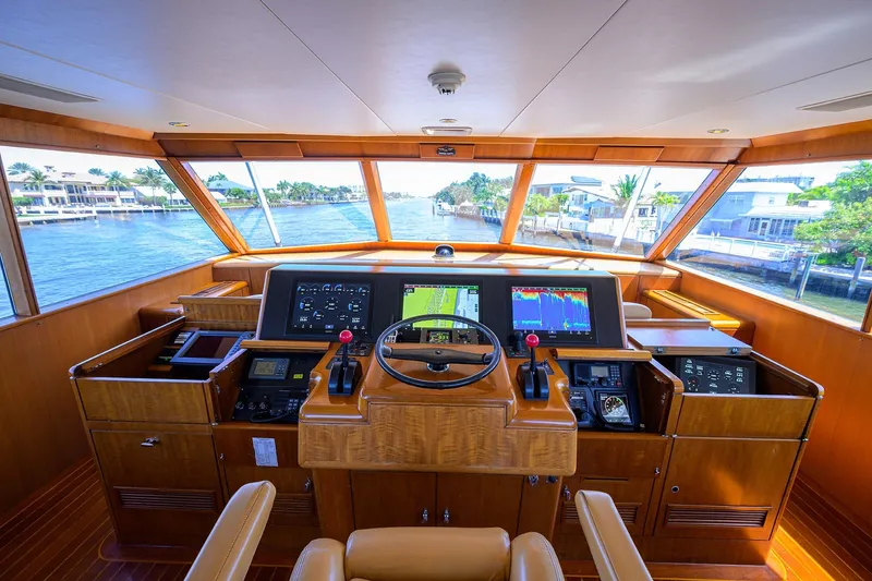 Slide: The Image of 1985 Feadship Yacht Fisherman helm with modern navigation equipment and panoramic waterway view. - 35