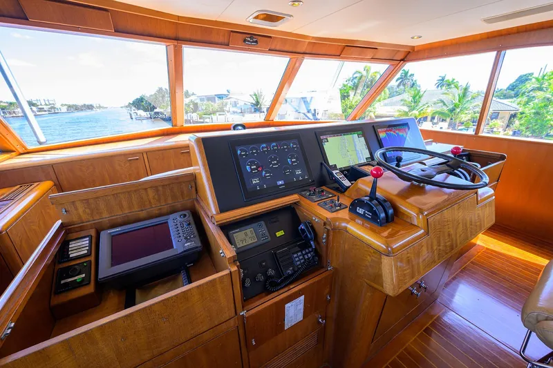 Slide: The Image of Cockpit of 1985 Feadship Yacht Fisherman with navigation equipment and wooden interior. - 36