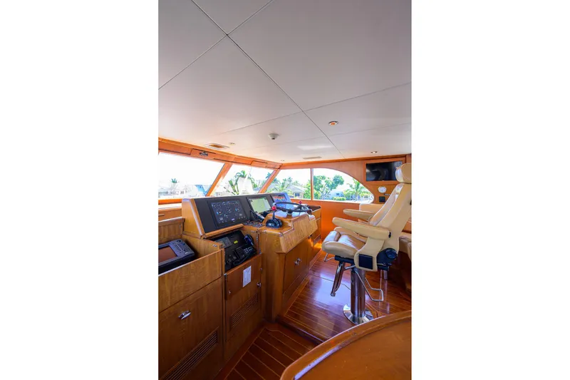 Slide: The Image of Interior of 1985 Feadship Yacht Fisherman, featuring navigation controls and captain's chair. - 37