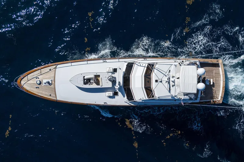 Slide: The Image of Aerial view of 1985 Feadship Yacht Fisherman cruising on open water. - 5