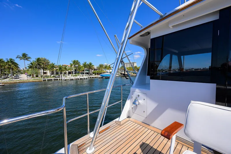 Slide: The Image of 1985 Feadship Yacht Fisherman deck with waterfront view and palm trees. - 54