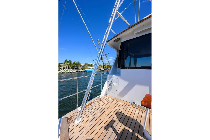 Slide: The Image of 1985 Feadship Yacht Fisherman deck with railing, blue sky, and waterfront view. - 55