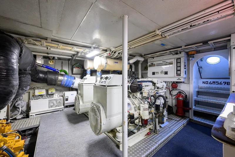 Slide: The Image of Engine room of a 1985 Feadship Yacht Fisherman, featuring machinery and equipment. - 59
