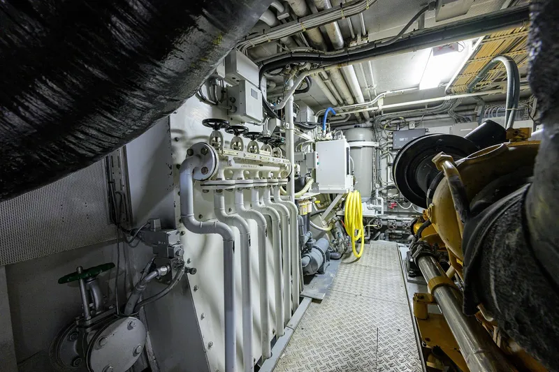 Slide: The Image of Engine room of 1985 Feadship Yacht Fisherman, showcasing machinery and piping systems. - 67