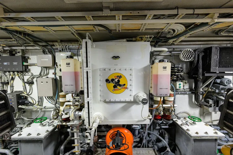 Slide: The Image of Engine room of a 1985 Feadship Yacht Fisherman, showcasing mechanical components and wiring. - 69