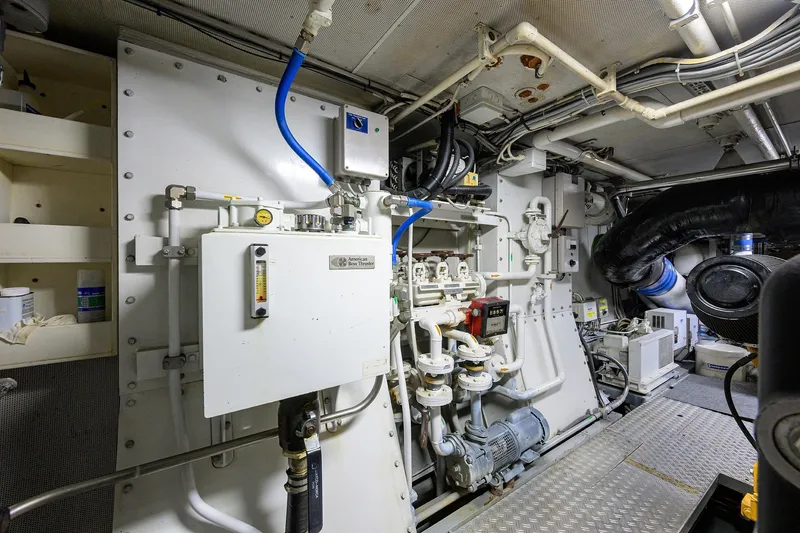 Slide: The Image of Engine room of 1985 Feadship Yacht Fisherman with complex piping and machinery. - 75