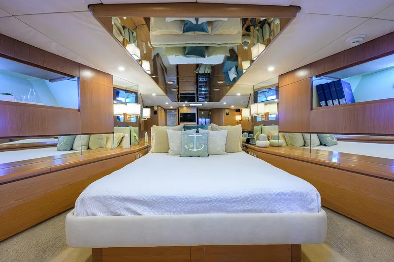 Slide: The Image of Luxurious 1985 Feadship Yacht Fisherman bedroom with elegant wood paneling and mirrored ceiling. - 78