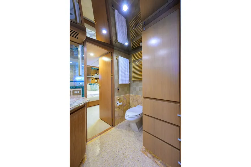Slide: The Image of Luxurious bathroom interior on 1985 Feadship Yacht Fisherman, featuring wood cabinetry and modern fixtures. - 86