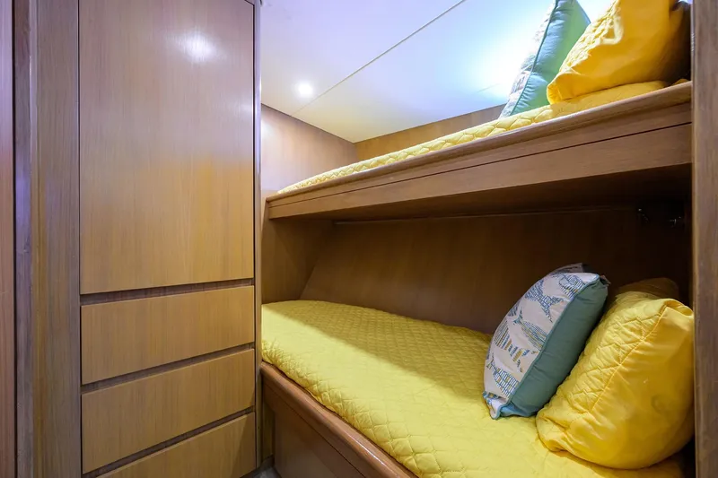 Slide: The Image of Cozy cabin with bunk beds on 1985 Feadship Yacht Fisherman, featuring yellow bedding and wooden interior. - 93