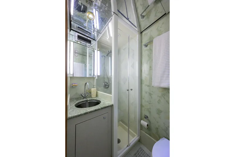 Slide: The Image of Luxurious bathroom in 1985 Feadship Yacht Fisherman, featuring shower and sink. - 95