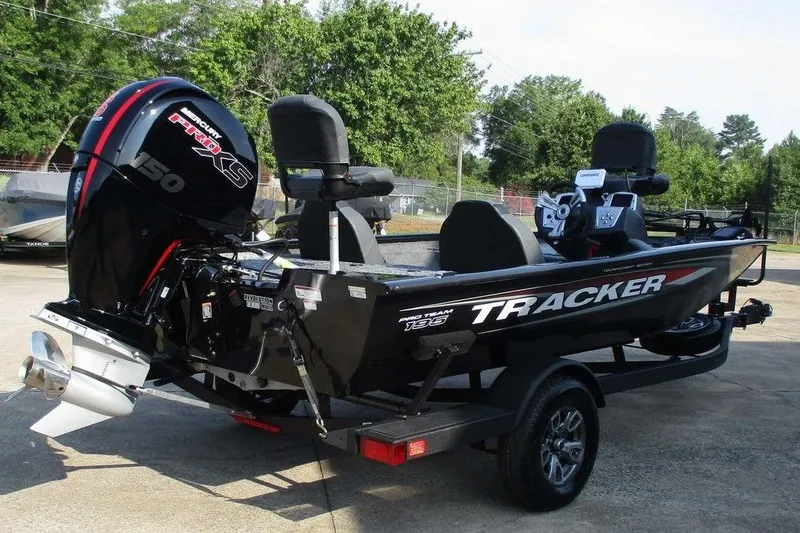 Slide: The Image of 2026 Tracker Pro Team 195 Tournament Edition boat with powerful engine, parked outdoors. - 7