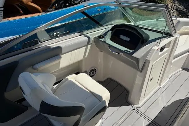 Slide: The Image of 2023 Chaparral 21 SSi boat interior with steering console and seating. - 10