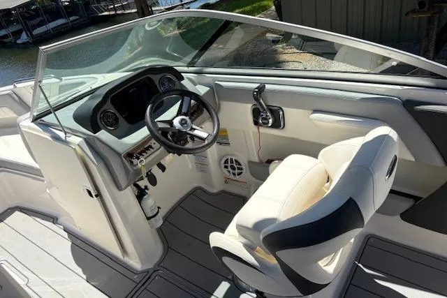 Slide: The Image of 2023 Chaparral 21 SSi boat interior with steering wheel and captain's seat. - 11