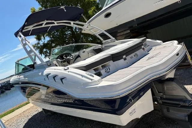 Slide: The Image of 2023 Chaparral 21 SSi boat with sleek design, docked near a serene waterfront. - 3