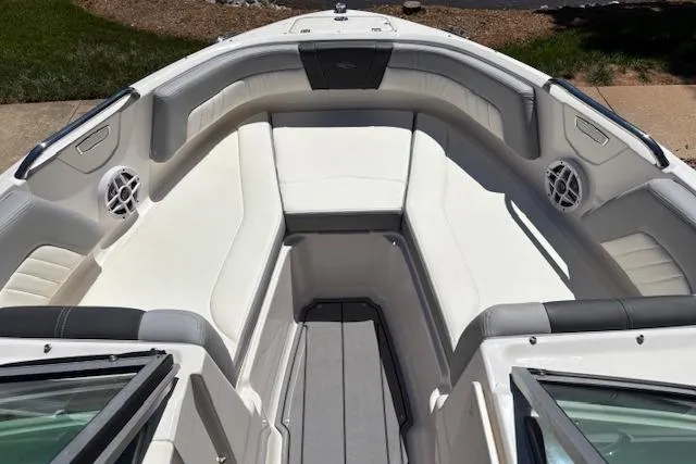 Slide: The Image of 2023 Chaparral 21 SSi boat interior with white cushioned seating and modern design. - 4