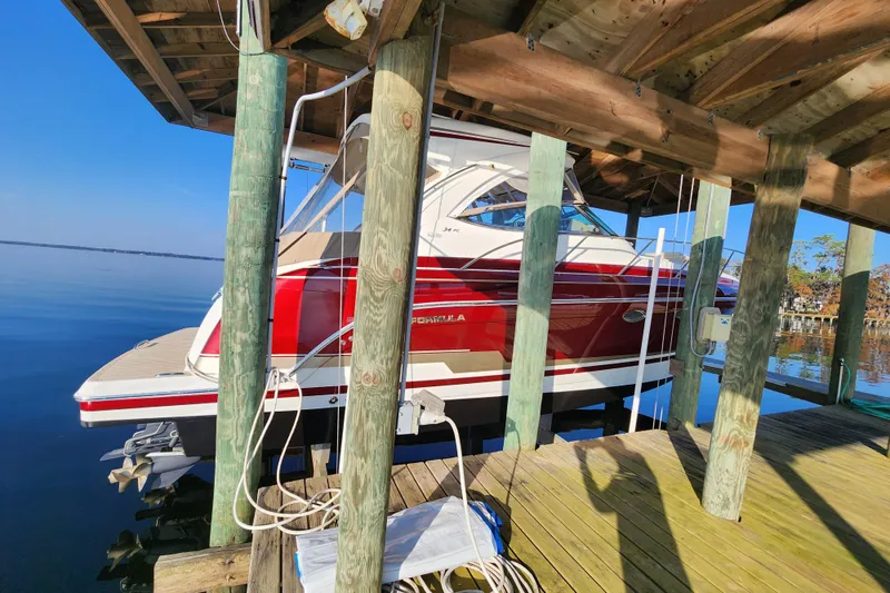 Slide: The Image of 2015 Formula 34 Performance Cruiser docked under wooden shelter on calm water. - 13