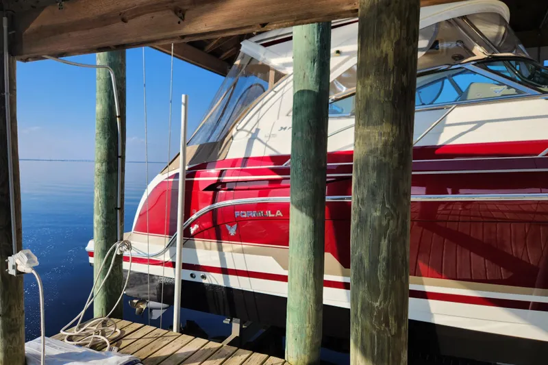 Slide: The Image of 2015 Formula 34 Performance Cruiser docked, featuring sleek red and white design. - 15