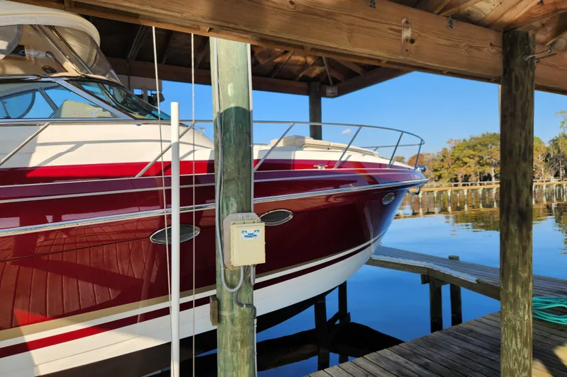 Slide: The Image of 2015 Formula 34 Performance Cruiser docked under wooden shelter by the water. - 16