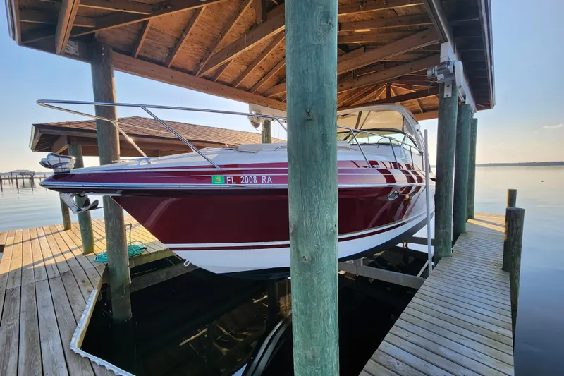 Slide: The Image of 2015 Formula 34 Performance Cruiser docked under wooden shelter by the water. - 18