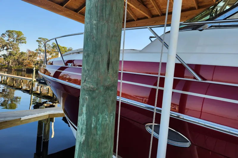 Slide: The Image of 2015 Formula 34 Performance Cruiser docked under wooden shelter. - 19