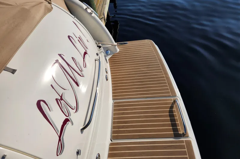 Slide: The Image of 2015 Formula 34 Performance Cruiser with teak deck, docked by calm water. - 23