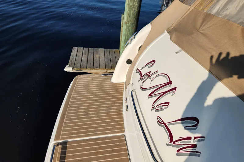 Slide: The Image of 2015 Formula 34 Performance Cruiser docked, featuring elegant lettering and wooden deck. - 24