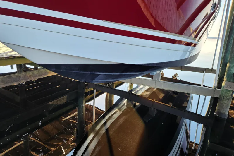 Slide: The Image of 2015 Formula 34 Performance Cruiser on a boat lift, reflecting in calm water. - 27