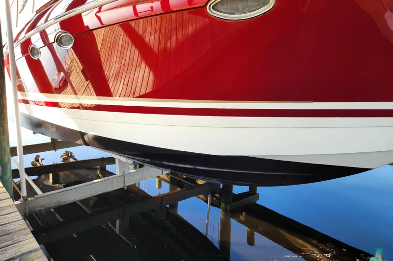 Slide: The Image of Red 2015 Formula 34 Performance Cruiser on boat lift, reflecting in calm water. - 28