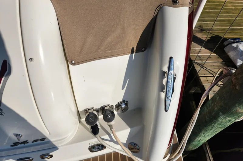 Slide: The Image of 2015 Formula 34 Performance Cruiser boat docked, showing power connections and branding. - 30