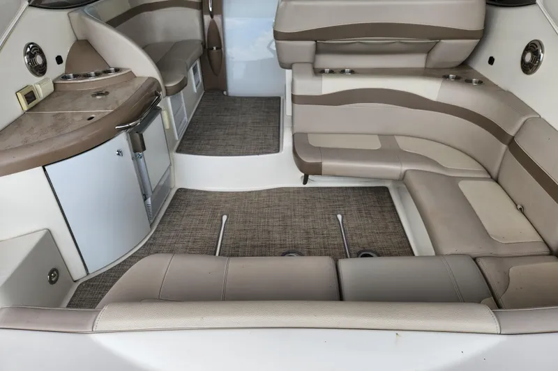 Slide: The Image of 2015 Formula 34 Performance Cruiser interior with beige seating and compact kitchenette. - 44