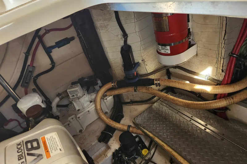 Slide: The Image of Engine compartment of a 2015 Formula 34 Performance Cruiser with visible hoses and fire extinguisher. - 53