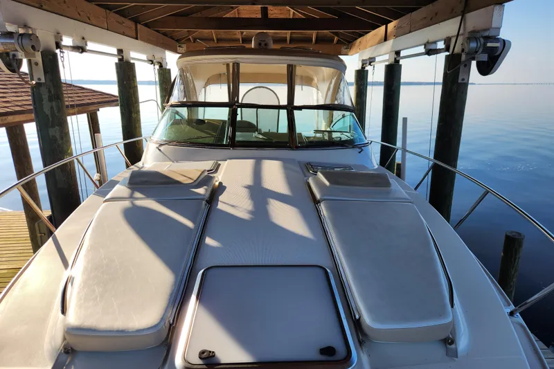 Slide: The Image of 2015 Formula 34 Performance Cruiser docked under a wooden canopy on calm water. - 56