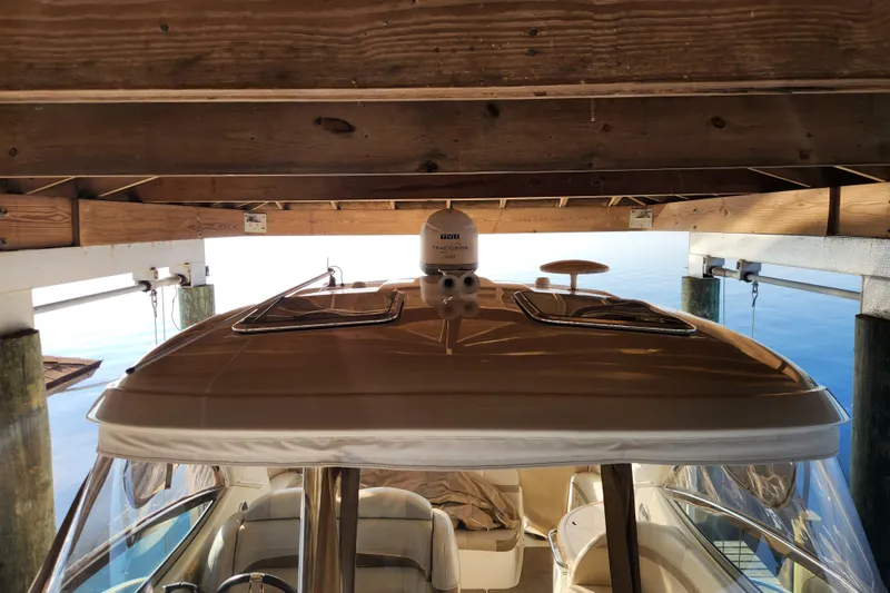 Slide: The Image of 2015 Formula 34 Performance Cruiser docked under wooden shelter. - 57