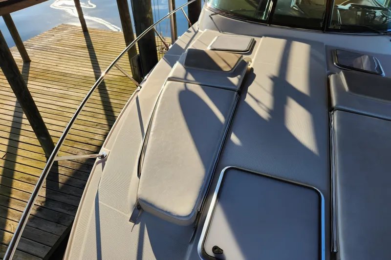 Slide: The Image of 2015 Formula 34 Performance Cruiser deck with sun pads and dock view. - 61