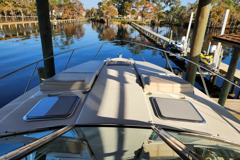 Slide: The Image of 2015 Formula 34 Performance Cruiser docked on a serene lake with autumn foliage. - 62
