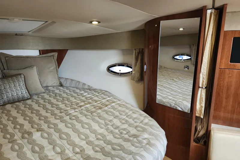 Slide: The Image of 2015 Formula 34 Performance Cruiser cabin with bed, mirror, and porthole window. - 68