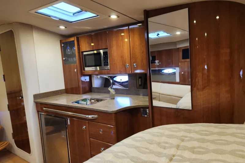 Slide: The Image of Luxurious interior of 2015 Formula 34 Performance Cruiser with kitchenette and wood finish. - 69