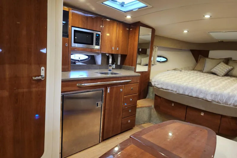 Slide: The Image of 2015 Formula 34 Performance Cruiser interior with kitchenette and cozy sleeping area. - 70
