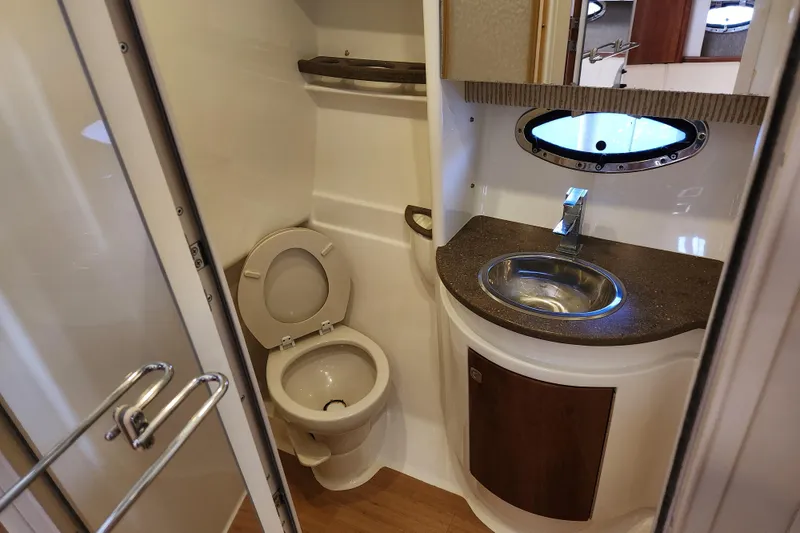 Slide: The Image of 2015 Formula 34 Performance Cruiser bathroom with toilet, sink, and porthole window. - 74