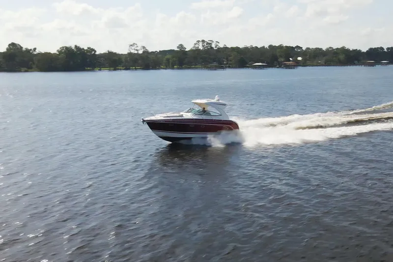 Slide: The Image of 2015 Formula 34 Performance Cruiser speeding on a serene lake. - 8