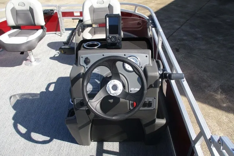 Slide: The Image of 2026 Sun Tracker Bass Buggy® 16 XL Select boat dashboard with steering wheel and controls. - 10