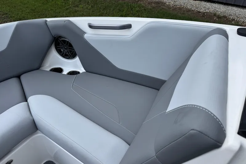 Slide: The Image of 2022 MasterCraft NXT20 boat interior with gray seating and speaker detail. - 10